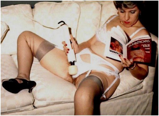 woman in fancy lingerie reading Penthouse Variations with one hand and masturbating with her Magic Wand