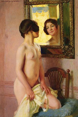 nude girl looks in mirror