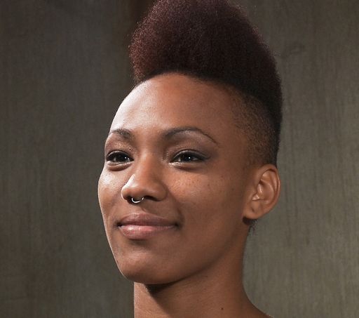 Nikki Darling sporting a nose ring and a mohawk-shaped afro