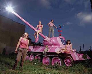 bikini girl riding the main gun of a pink tank