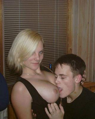 smug girl lets young man lick her boob