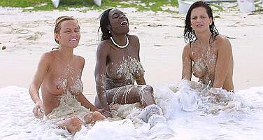 three nudes enjoying the beach surf