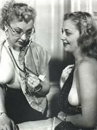patient modestly holds her blouse over her bare breasts while the nurse or doctor takes a note of her vital signs