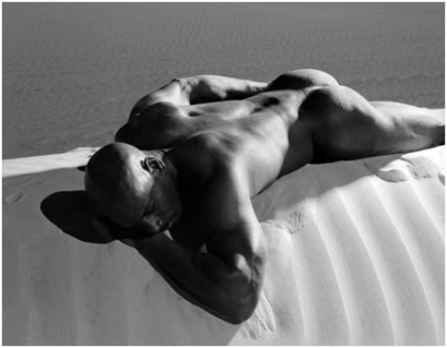 Nude man on a sand dune