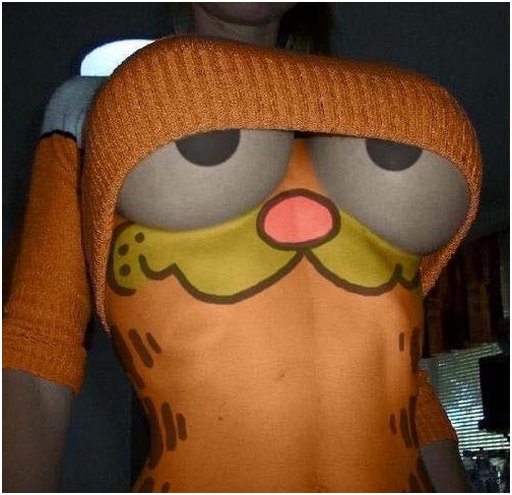 semi topless woman with cosplay body paint and orange sweater dressed as Garfield with her big tits painted to look like his cartoon eyes