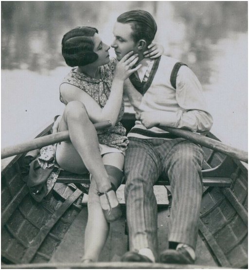 a deep romantic kiss in a rowboat