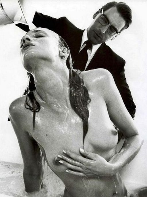 man in a suit helps a naked beauty take a bath