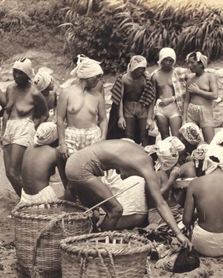 nude divers on beach with baskets