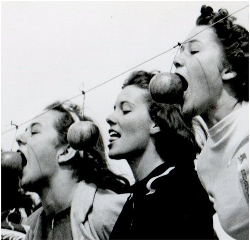 girl with pretty lips and tongue is shy about biting an apple in public