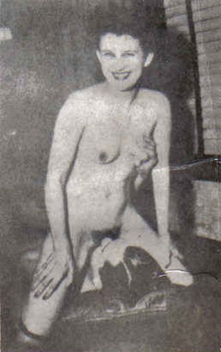 woman smiling for the camera while she sits on a man\'s face and he tweaks her nipple