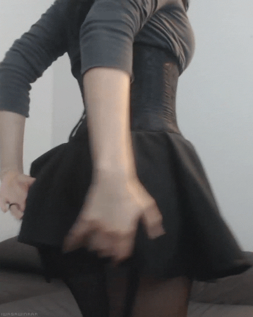 corseted woman shows off her luscious booty