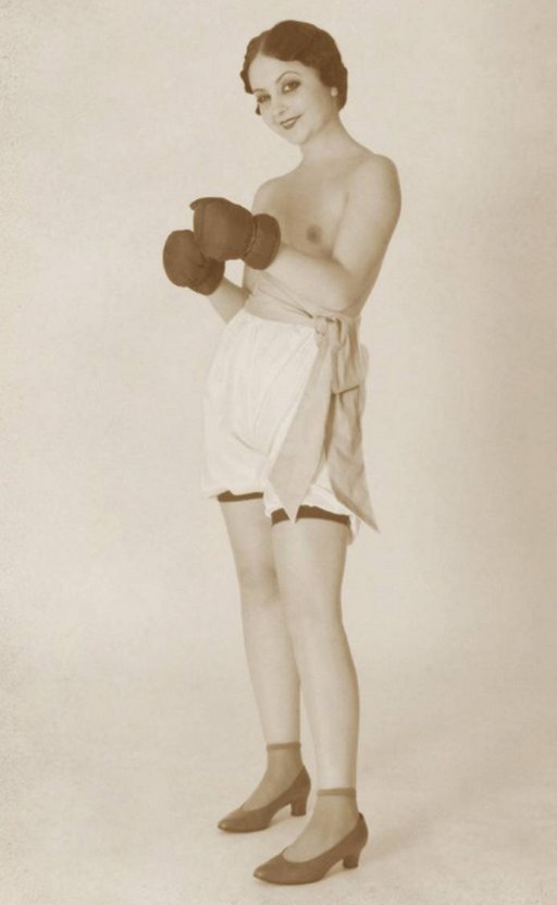 topless vintage woman wearing boxing gloves