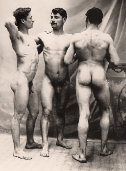 three buff naked men standing around admiring each other and their nude bodies