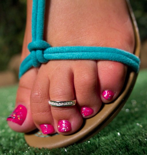 pretty feet with painted toenails and a toe ring