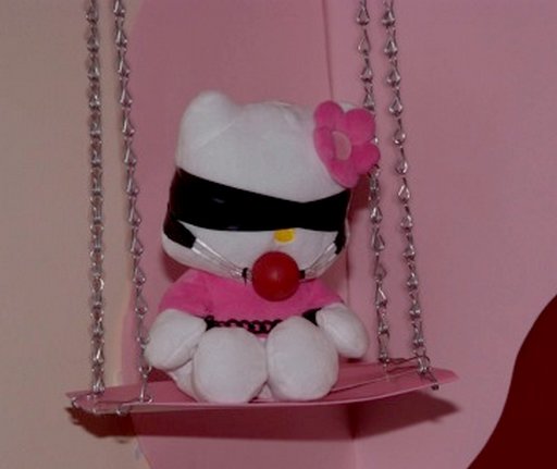 Hello Kitty doll wearing blindfold and gag