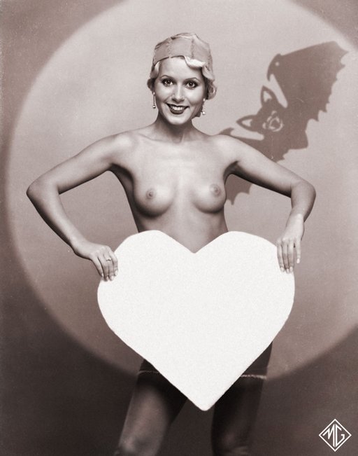 valentines day at halloween as burlesque cutie hides behind heart shaped cardboard skeleton head