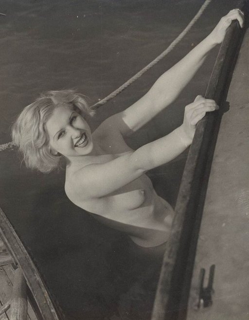 naked lady climbing into a boat