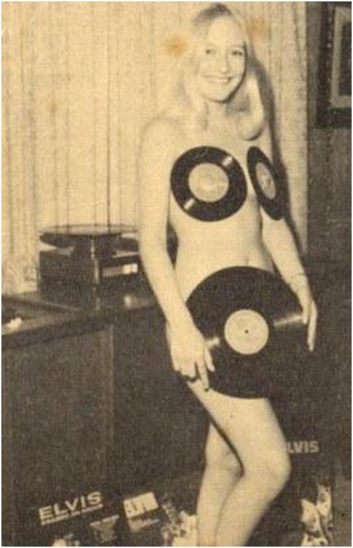 naked elvis fan wearing 45 rpm records on her nipples