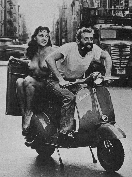 a glamour nude on a vespa scooter