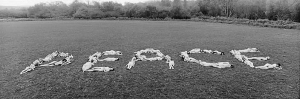 Naked people spell out peace