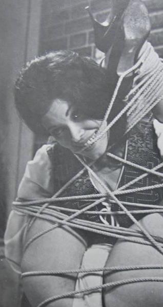 bondage model smiling through her ropes