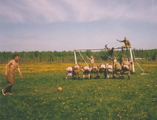 russian army guys mooning the camera during a soccer game