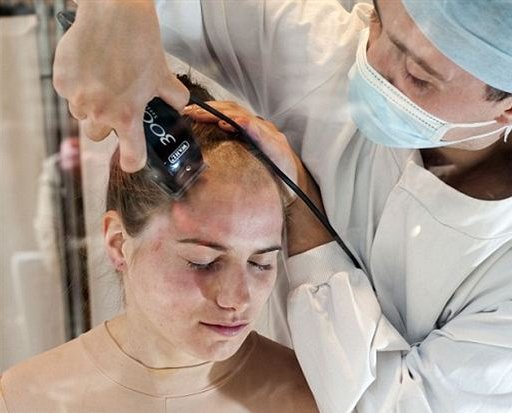 shaving the head of an animal rights activist