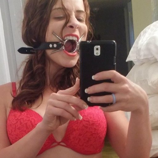 gagged girl taking a selfie in her new spider gag ring gag