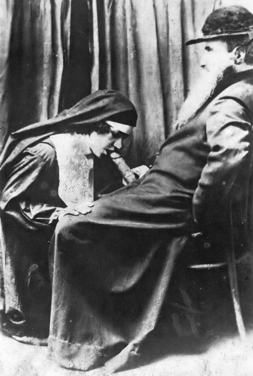 vintage photo of a kneeling nun giving a blowjob to a comfortably seated bearded patriarch
