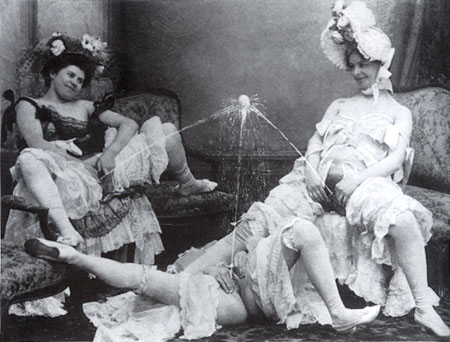 three women supporting a ball on streams of pee