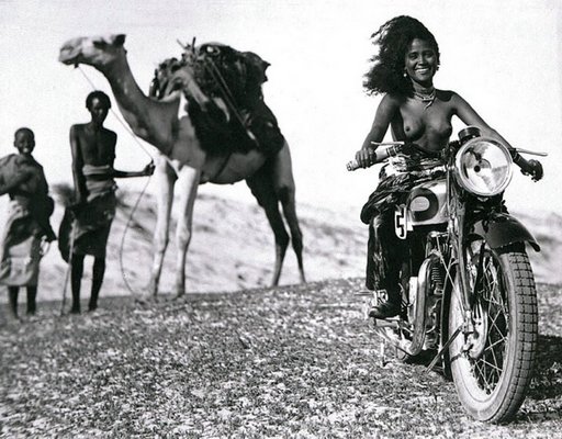 topless female motorcyclist in north africa photo