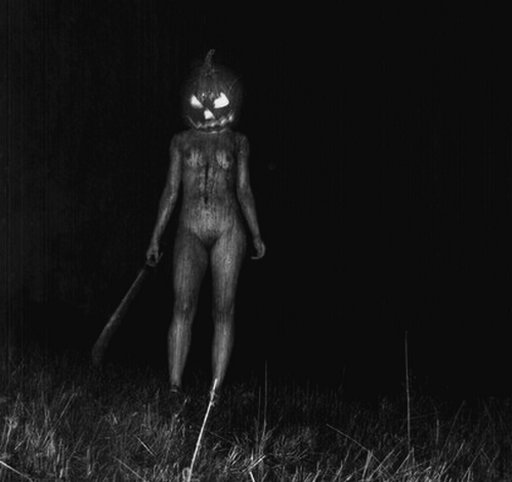 scary halloween nude with a machete and glowing pumpkin head