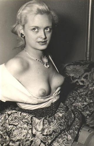 vintage topless blonde looks uncertainly at the photographer
