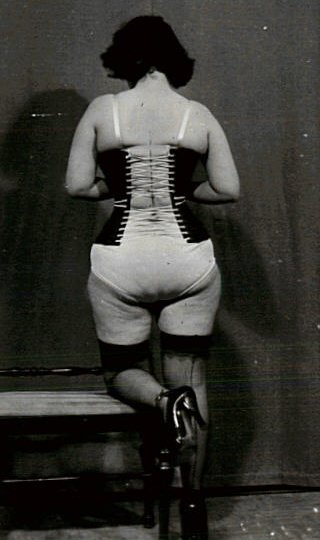 curvy woman lacing her corset