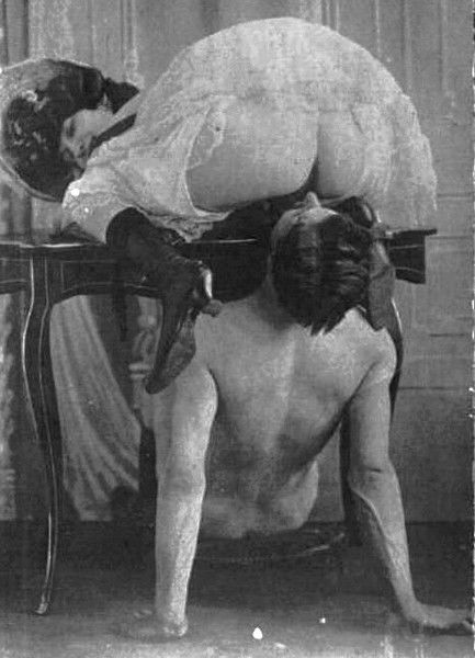 woman kneeling on a table with her pussy over a man\'s face