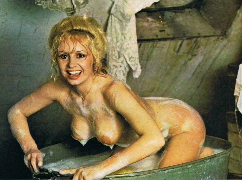 blonde with soapy tits on her knees in a metal bathtub