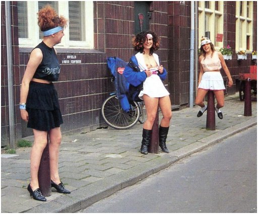 three porn starlets sitting on steel bollards in Amsterdam