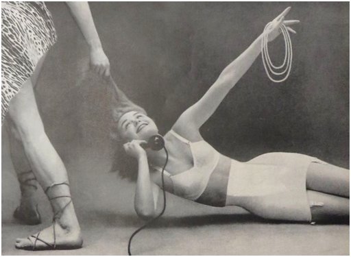 woman in lingerie being dragged by a caveman pulling her hair while she cheerfully chats on the phone