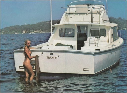 nude blonde climbing up the swim ladder on the motor yacht Franco