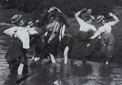 victorian women splashing in a cool stream with their skirts tucked up