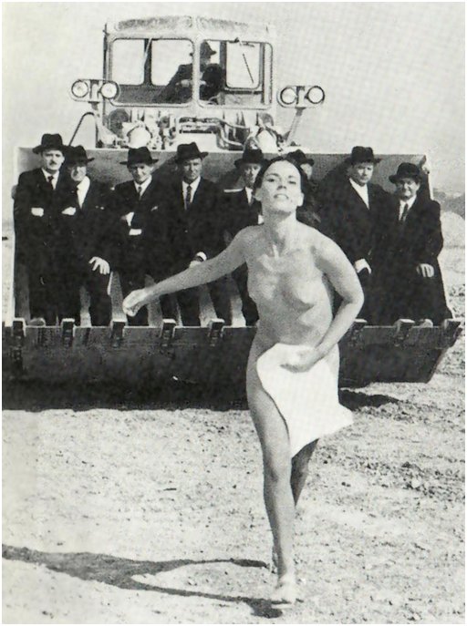 naked woman with a towel fleeing from a bunch of men in dark hats and suits riding on an excavator killdozer