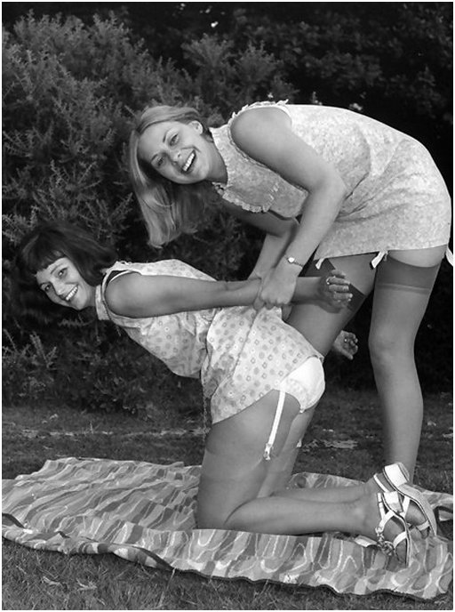vintage lesbians pinup models in nylon stockings with garter belts cat fight and wrestle on a picnic blanket