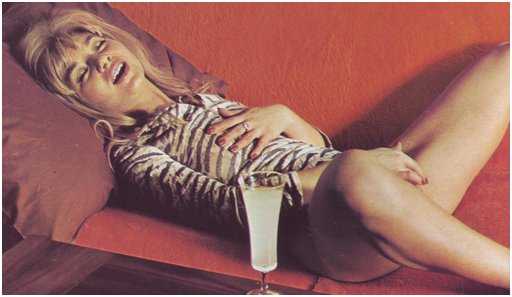 woman relaxing with a mixed drink after solo pleasure