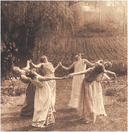 six girls dancing and performing spring magic in an orchard