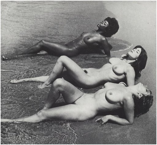 three women lounging and sunbathing in the surf on Rhodes in the Aegean