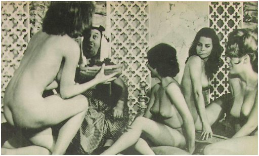 pasha or sheik ogles one of four women who are naked in a harem scene from My Tale Is Hot nudie film 1964