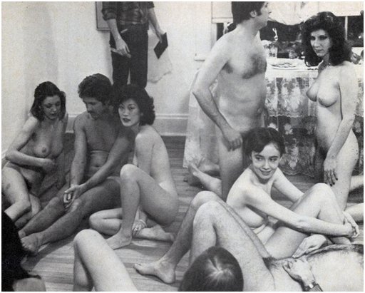 about ten cast members of a 1970s porn movie lounge nude during a break in the filming of an orgy scene