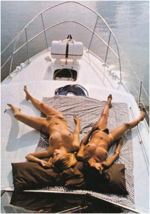 two nude yacht bunnies sunbathing aboard